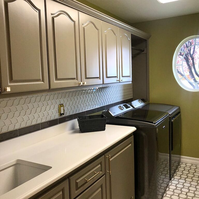 Painted gray laundry room cabinets
