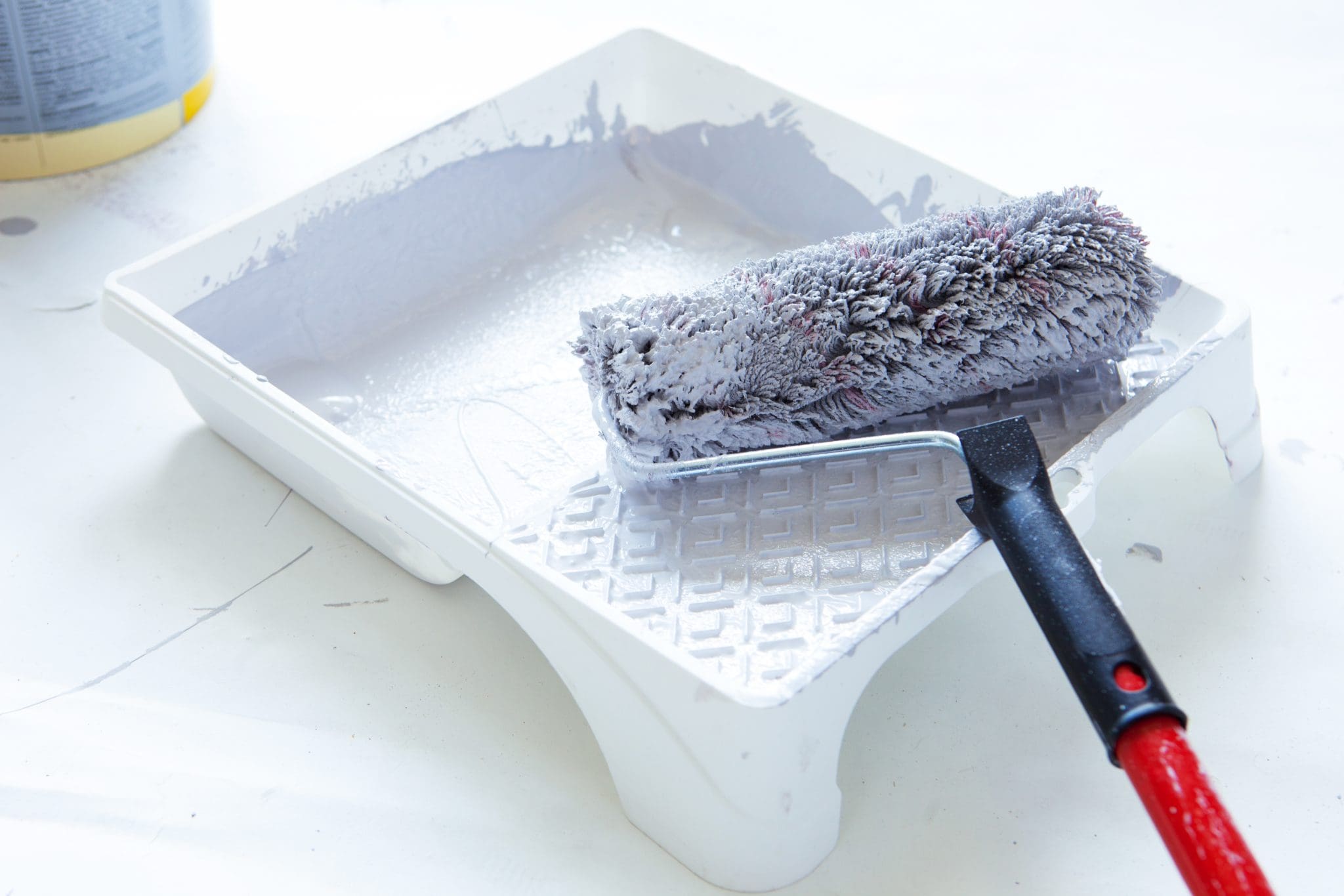 Paint roller laying in paint tray